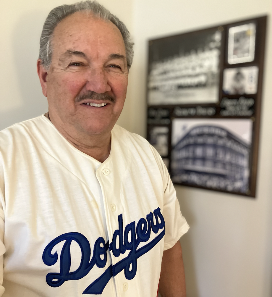 A man poses in a Dodgers jersey