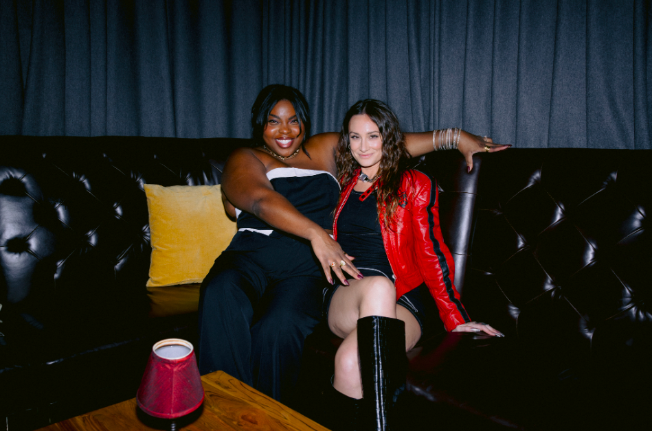 Two women sit on a couch