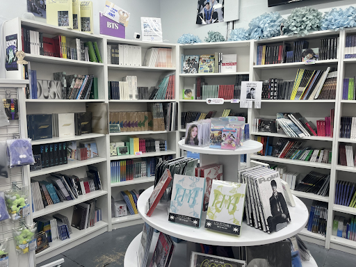 A display of books with bookshelves in the background.