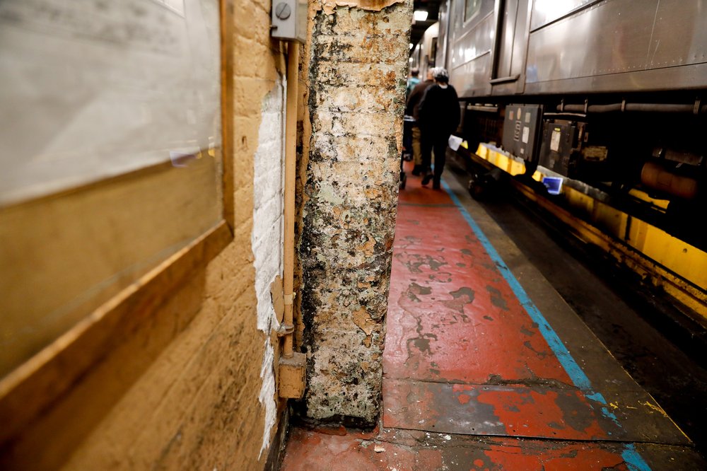 A crumbling column in a train yard.