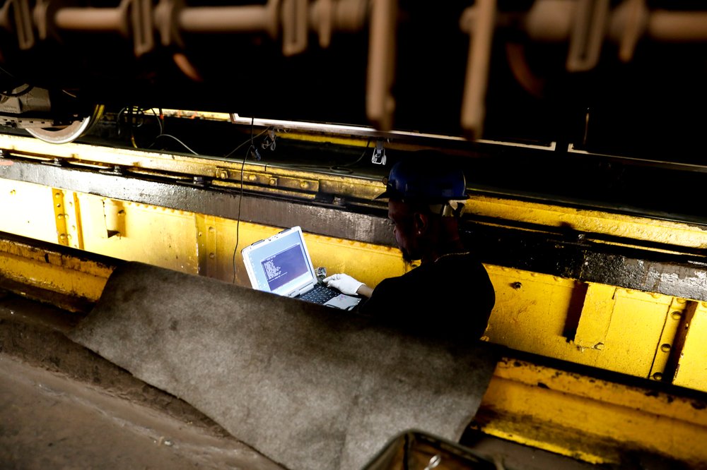 A worker diagnoses problems with a 3 train at Livonia Yard.