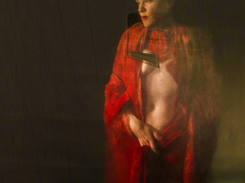 A picture of a nude woman wearing a red robe and looking off to the side.