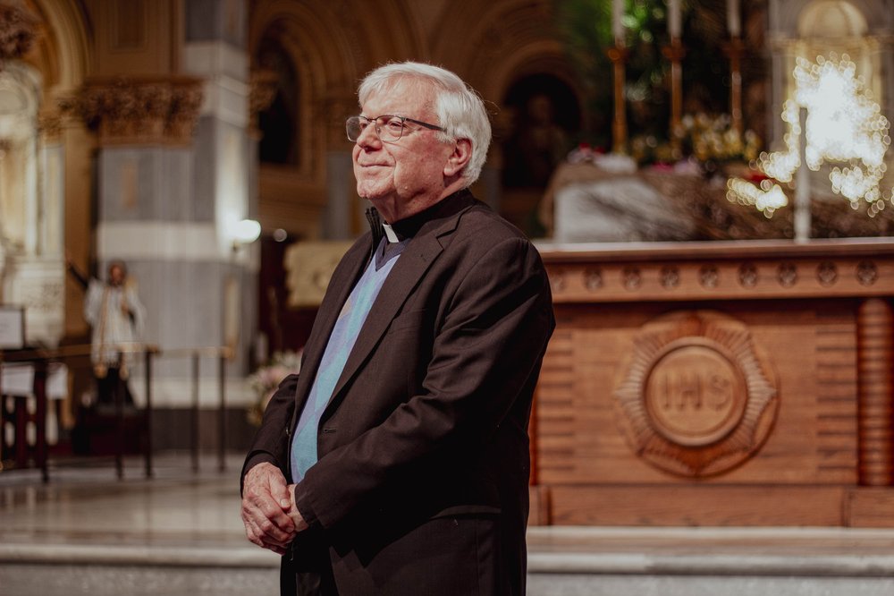 A man poses inside a church.