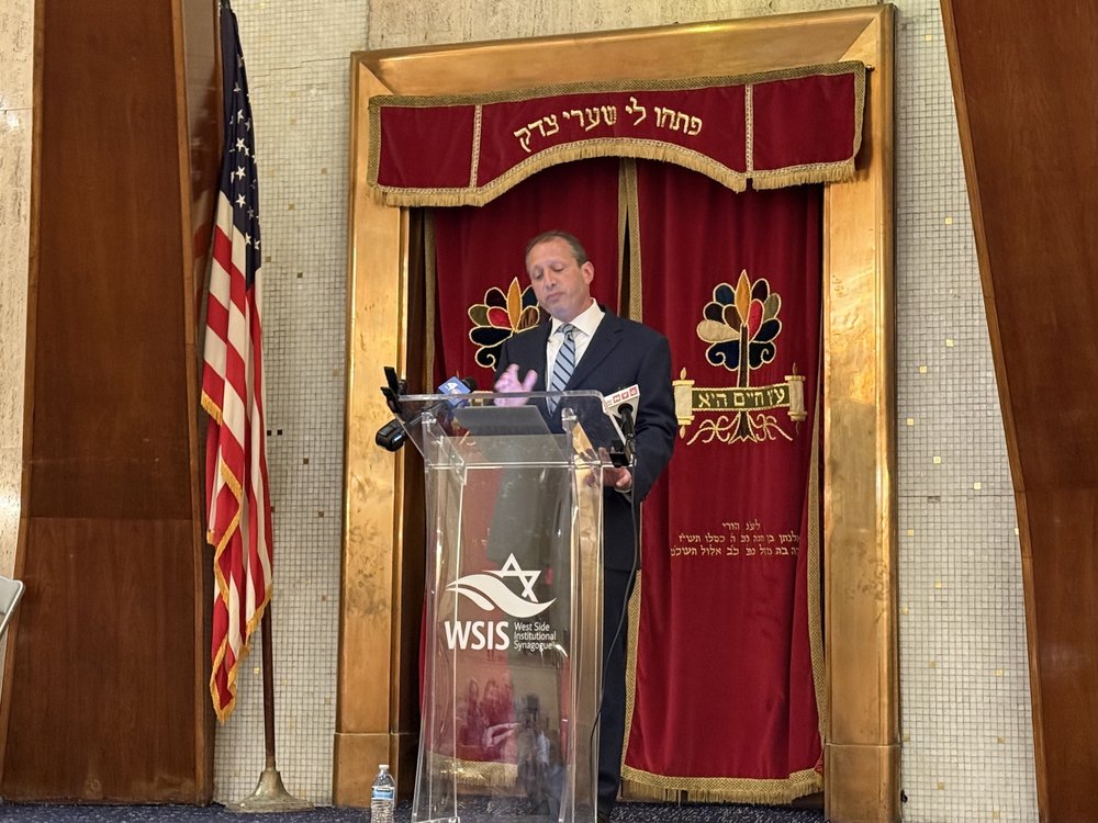 Brad Lander at a podium.