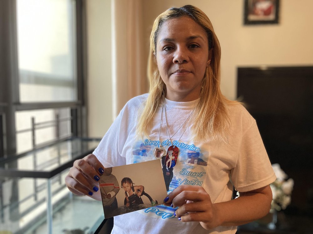 Lezandre Khadu holds a childhood photo of her son Stephan Khadu, who passed away after being held in the Vernon C. Bain Center in September.