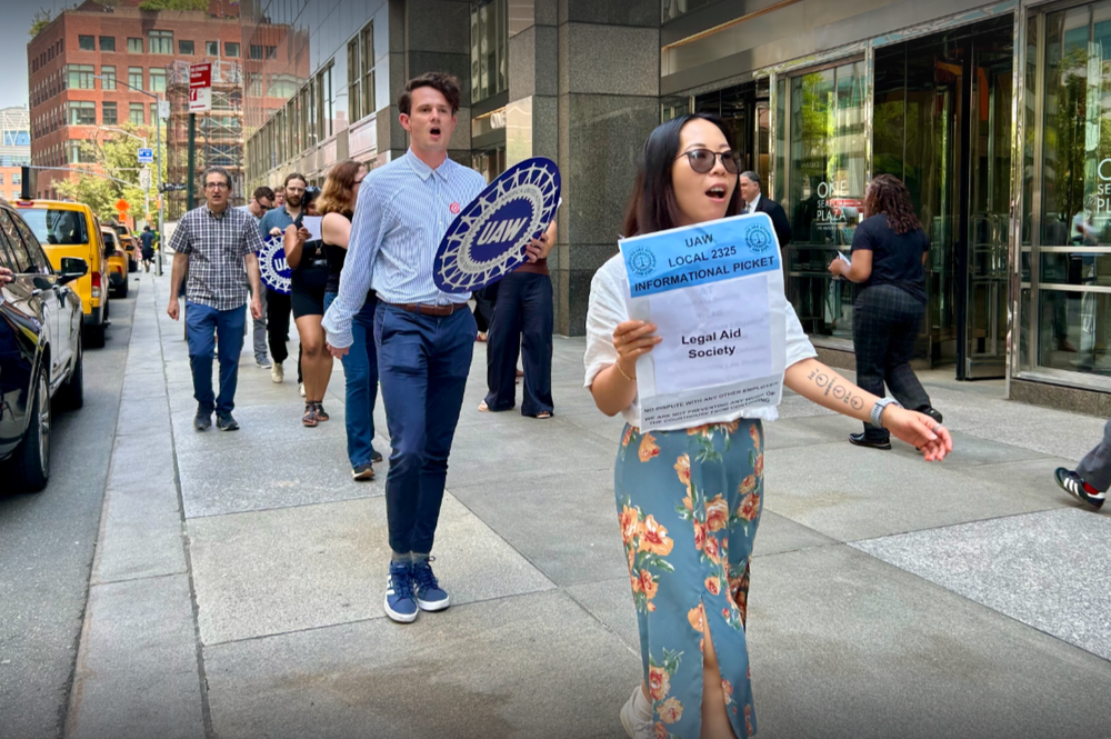 egal Aid Society attorneys chant and march at a practice picket outside the Manhattan office in June.