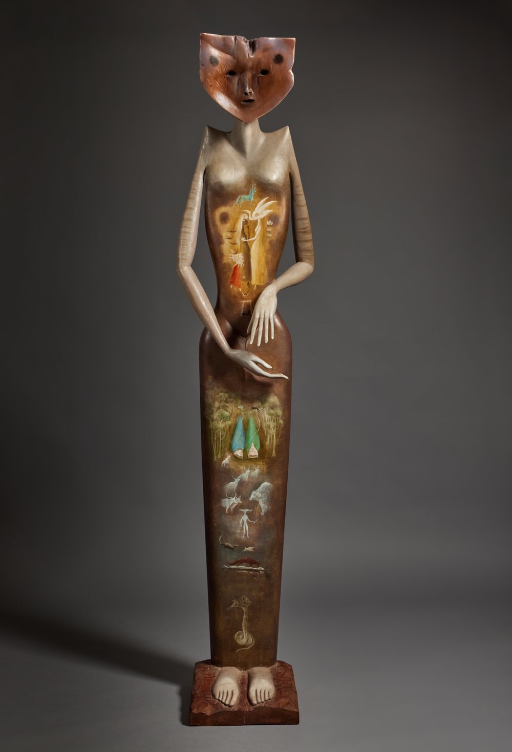 A painted wood sculpture in the shape of a woman.