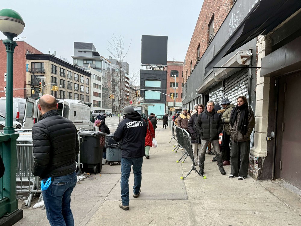 New Yorkers wait in line outside a theater.