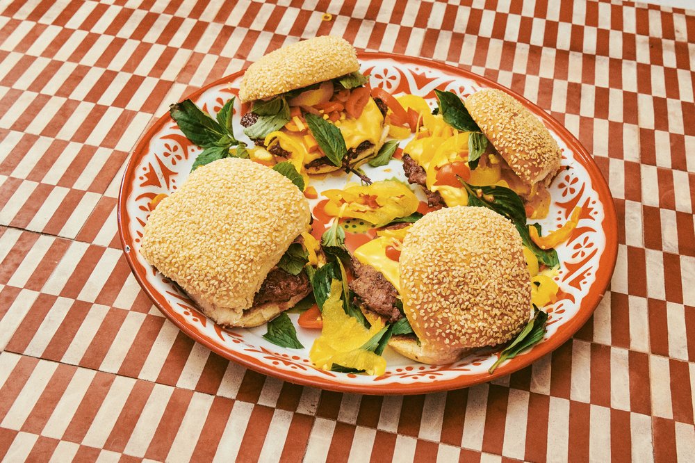 On top of the patties lies a friendly slice of American cheese and a pile of “Thai giardiniera”, pickled chiles.  A subtle swipe of mayo, turned red and fishy from the addition of shrimp-head XO sauce, hides beneath.