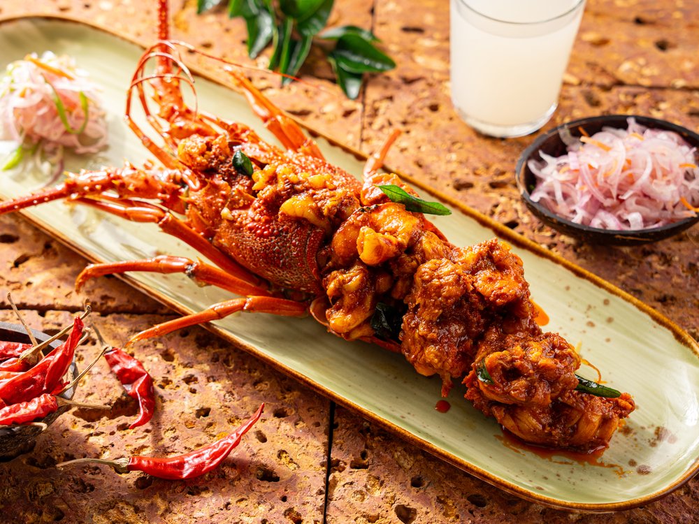 A lobster grilled and served on a plate.