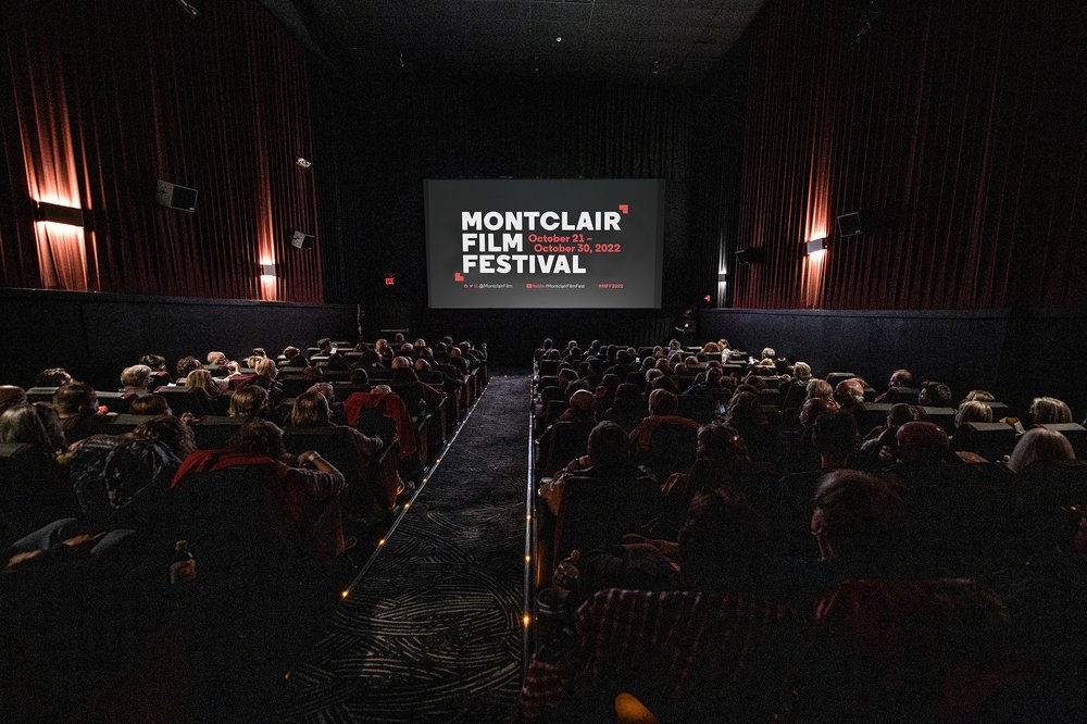 People watching a movie in a darkened theater.