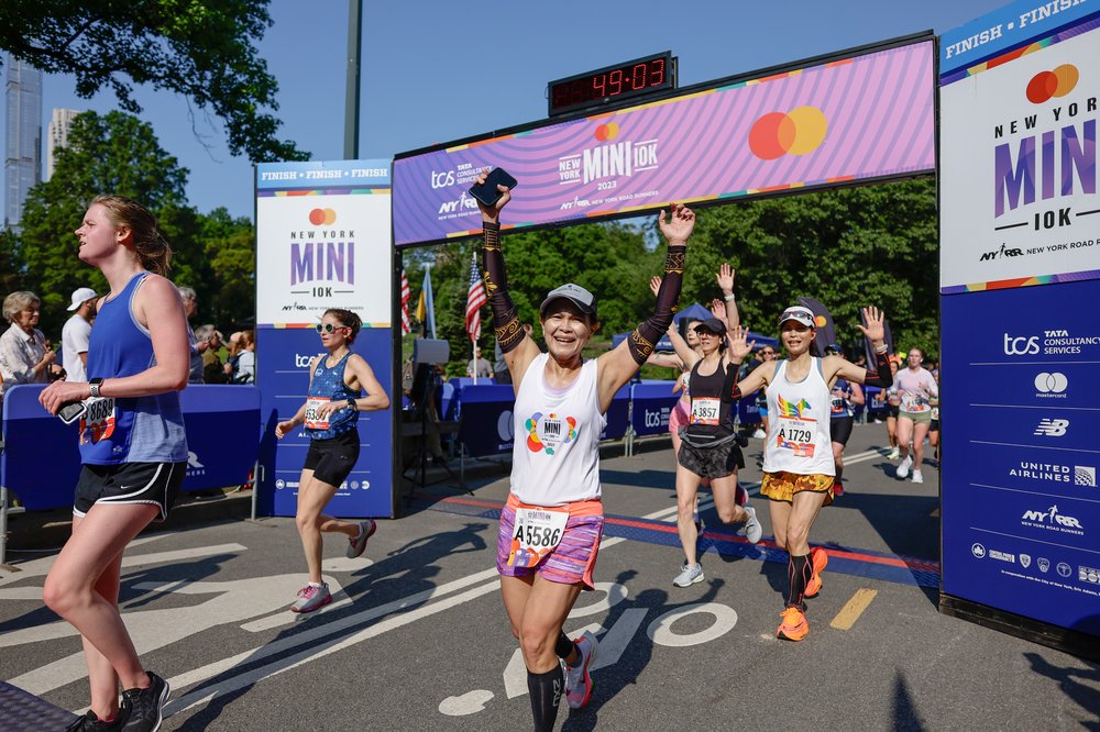 A photo of women crossing the finish line at Central Park's Mini 10K