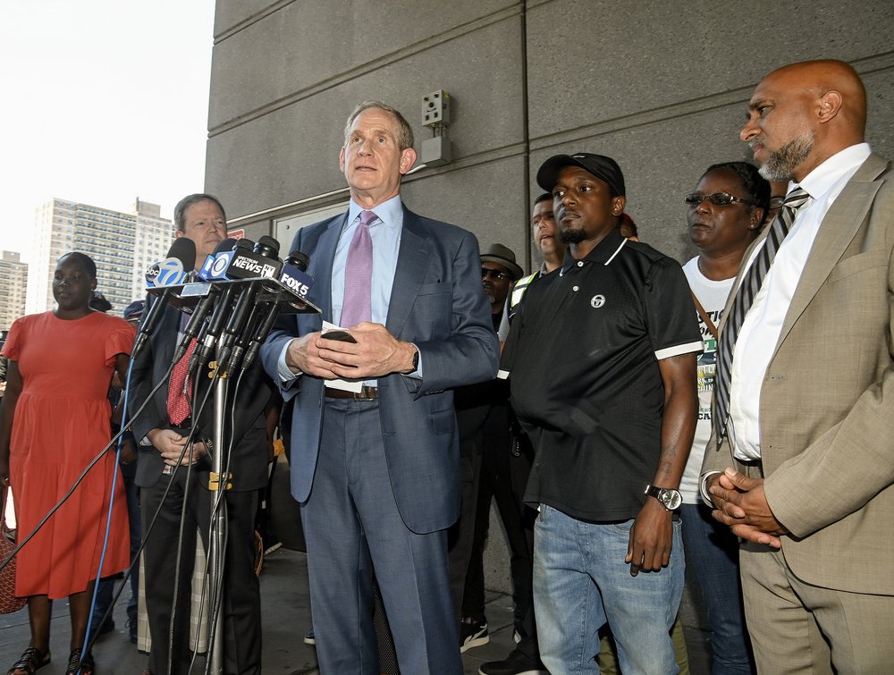 MTA chair and CEO Janno Lieber stands behind a podium at a news conference requesting Bronx District Attorney Darcel Clark request a judge ban a man accused of assaulting an MTA employee Anthony Nelson (to Janno's left wearing an arm cast) last week.