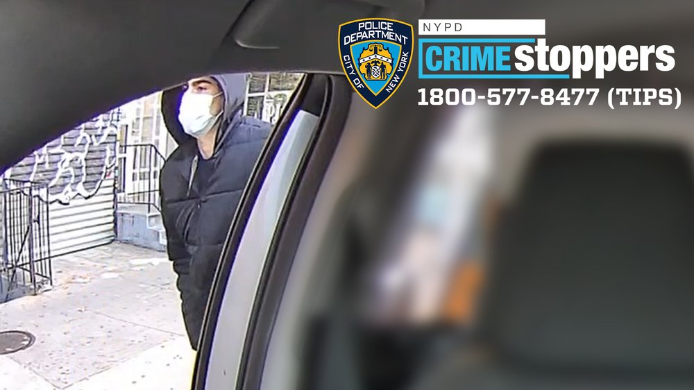 A man outside of a taxi cab.