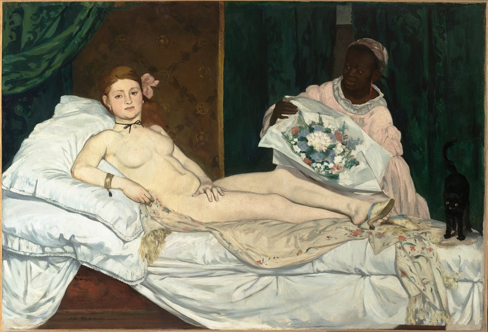 A woman lounges naked on a bed