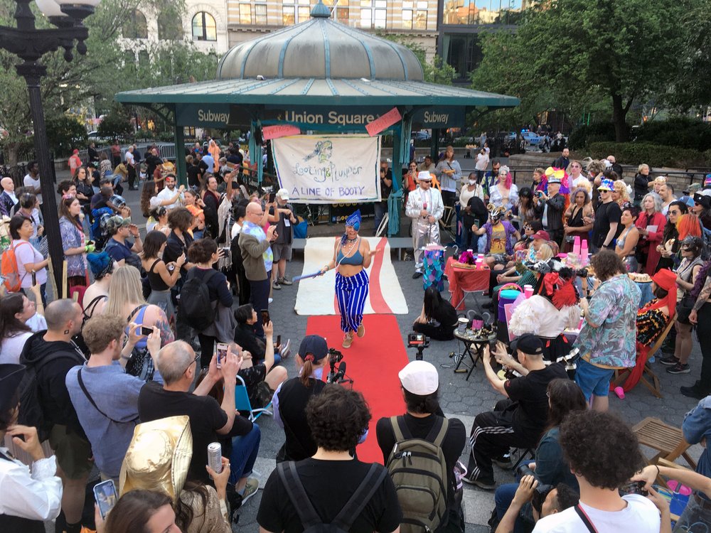 A group of people stand near Union Square.