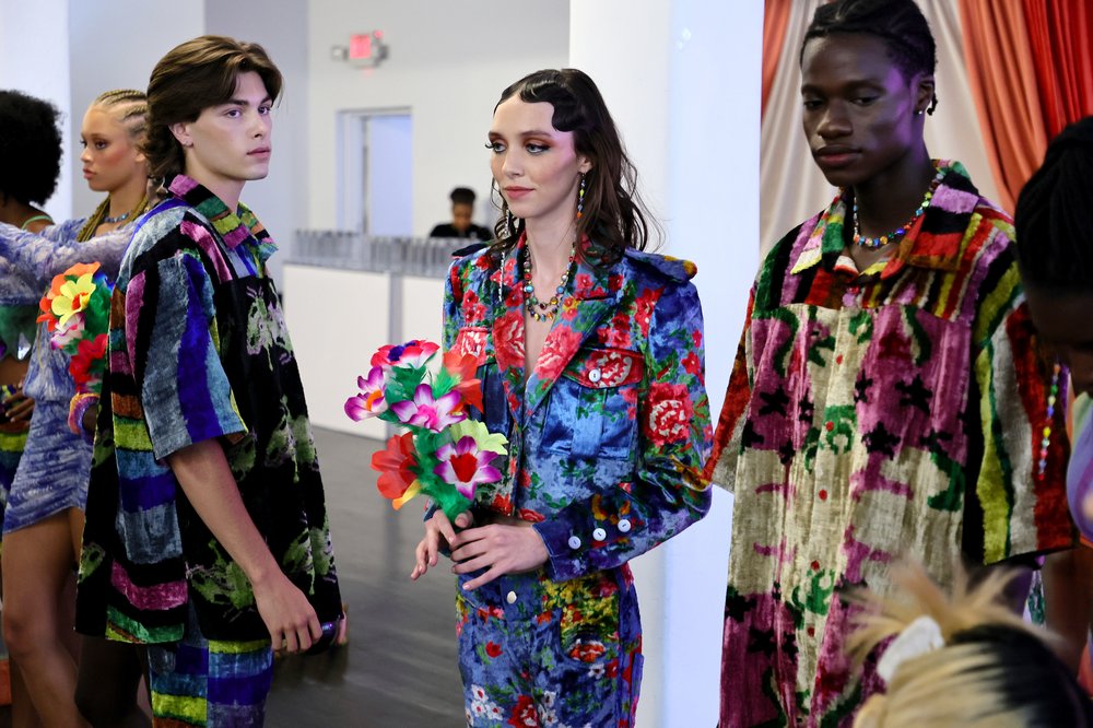 Models in bright jackets pose.