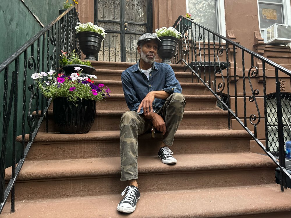 Michael Williams sits on his front stoop on Willoughby Avenue in the Bed-Stuy section of Brooklyn. The city's Landmarks Preservation Commission on Tuesday approved creation of the Willoughby-Hart Historic District.