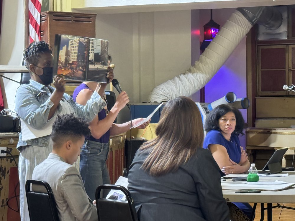 Neighbors of city shelters for migrants in the Clinton Hill section of Brooklyn gather in Brooklyn Masonic Temple to discuss their concerns over the facilities. Nearly 3,900 migrants occupy shelters in the community.