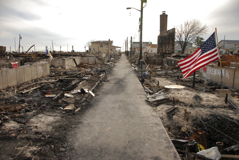 A charred alleyway runs between burnt ruins of homes in the Breezy Point neighborhood in Queens.