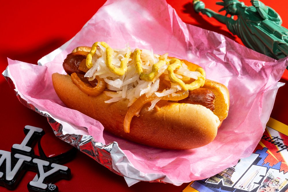 A photo of a classic New York Frank: Beef dogs with mustard, sauerkraut and stewed onions.