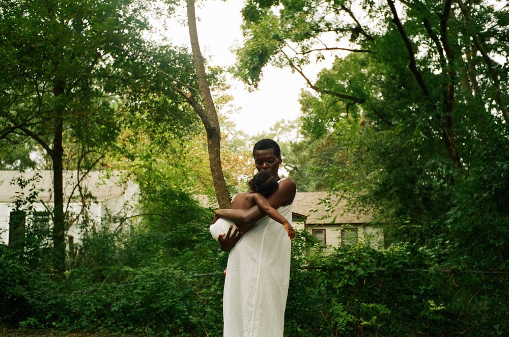 A picture of a woman holding a baby.