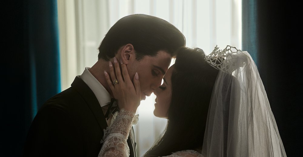 A picture of a bride kissing a groom.