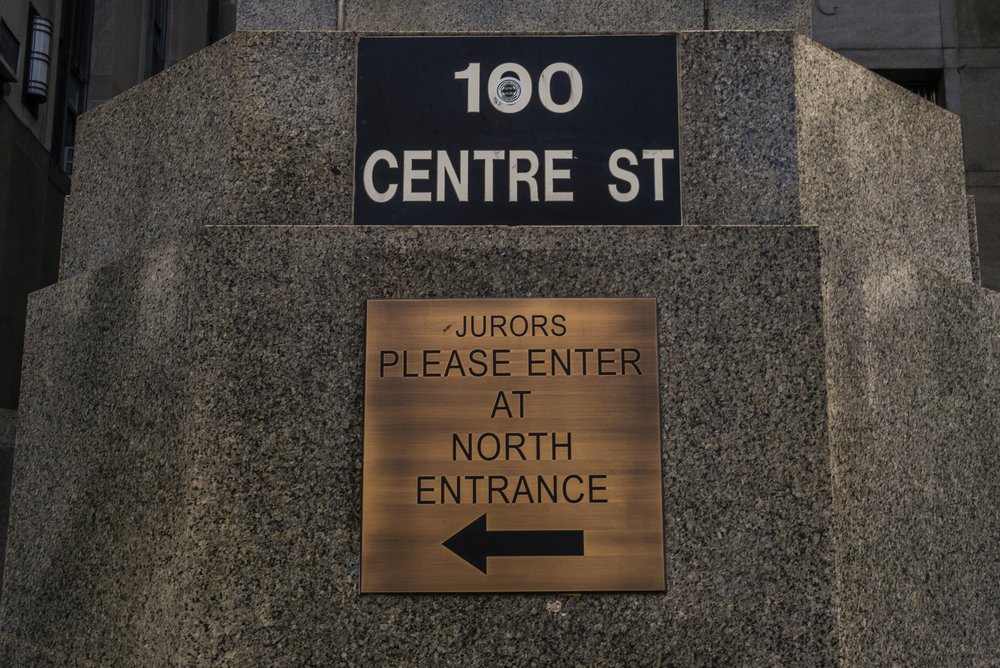 A gold sign reads: "Jurors please enter at North Entrance