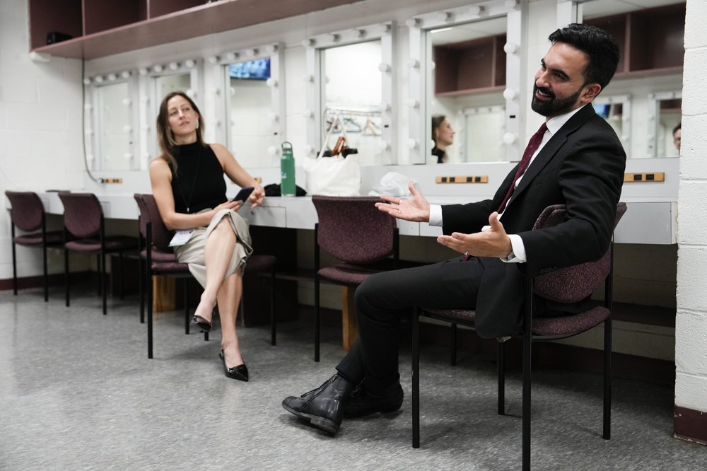 Zohran Mamdani backstage smiling.