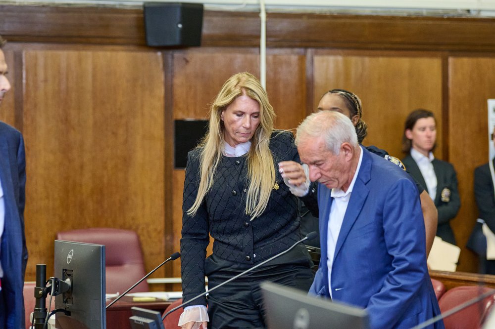 An older man and a woman with blonde hair in court.
