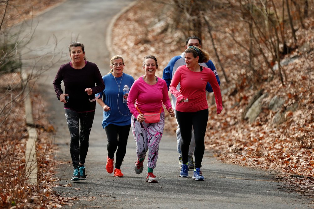 A group of joggers runs in Manhattan.