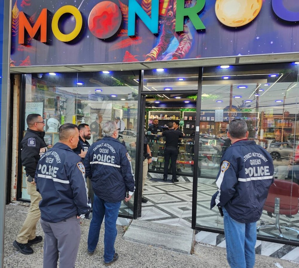 Queens DA investigators and NYPD officers enter Moonrocks in Flushing during a raid targeting illegal cannabis shops.