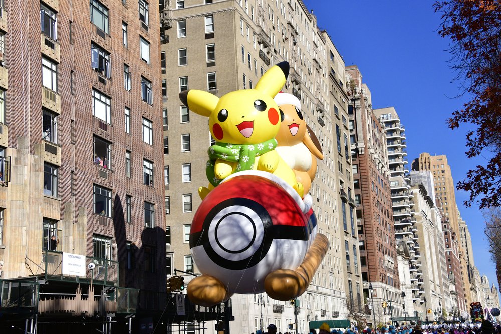 An enormous balloon of a yellow cartoon character, Pikachu.