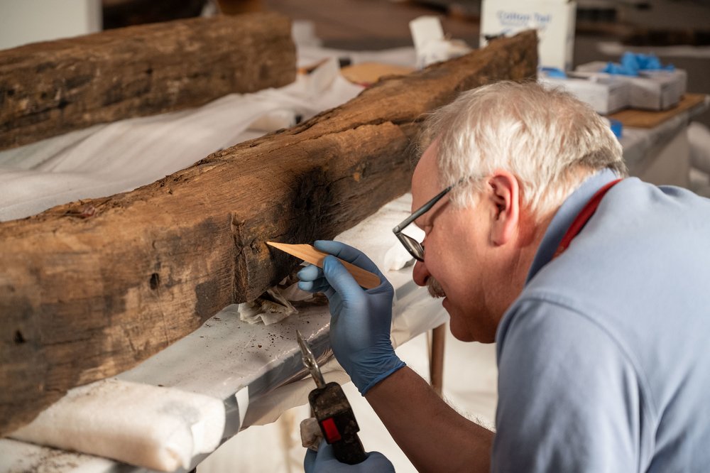 A historian working on timber.