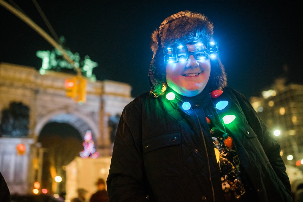 a person with a necklace made out of holiday lights