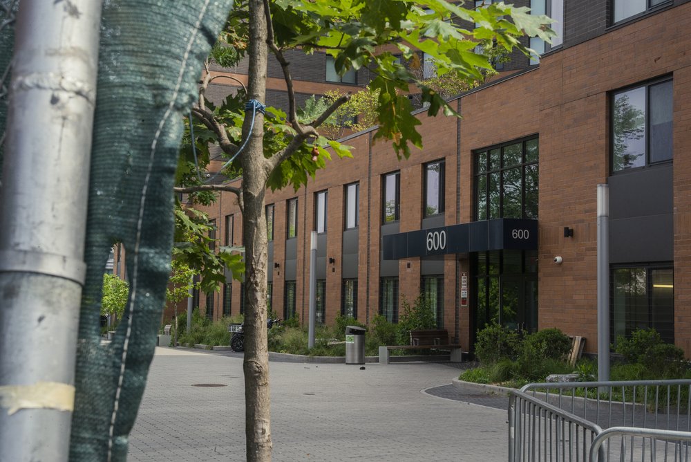 A modern residential building that prominently features the number "600."