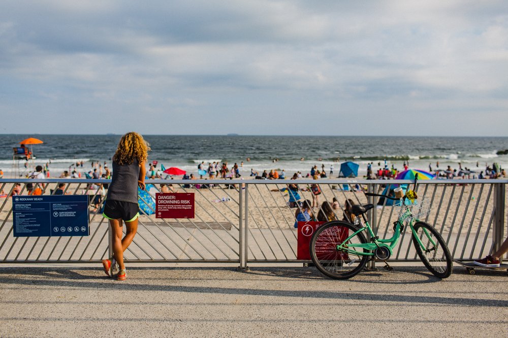 A woman looking out at the beach.