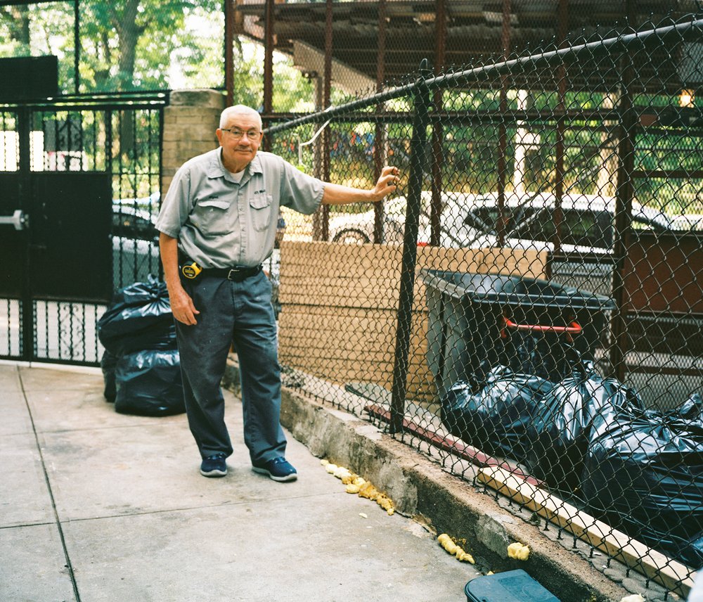 A man standing next to a fence on Gerard Avenue in the Bronx.