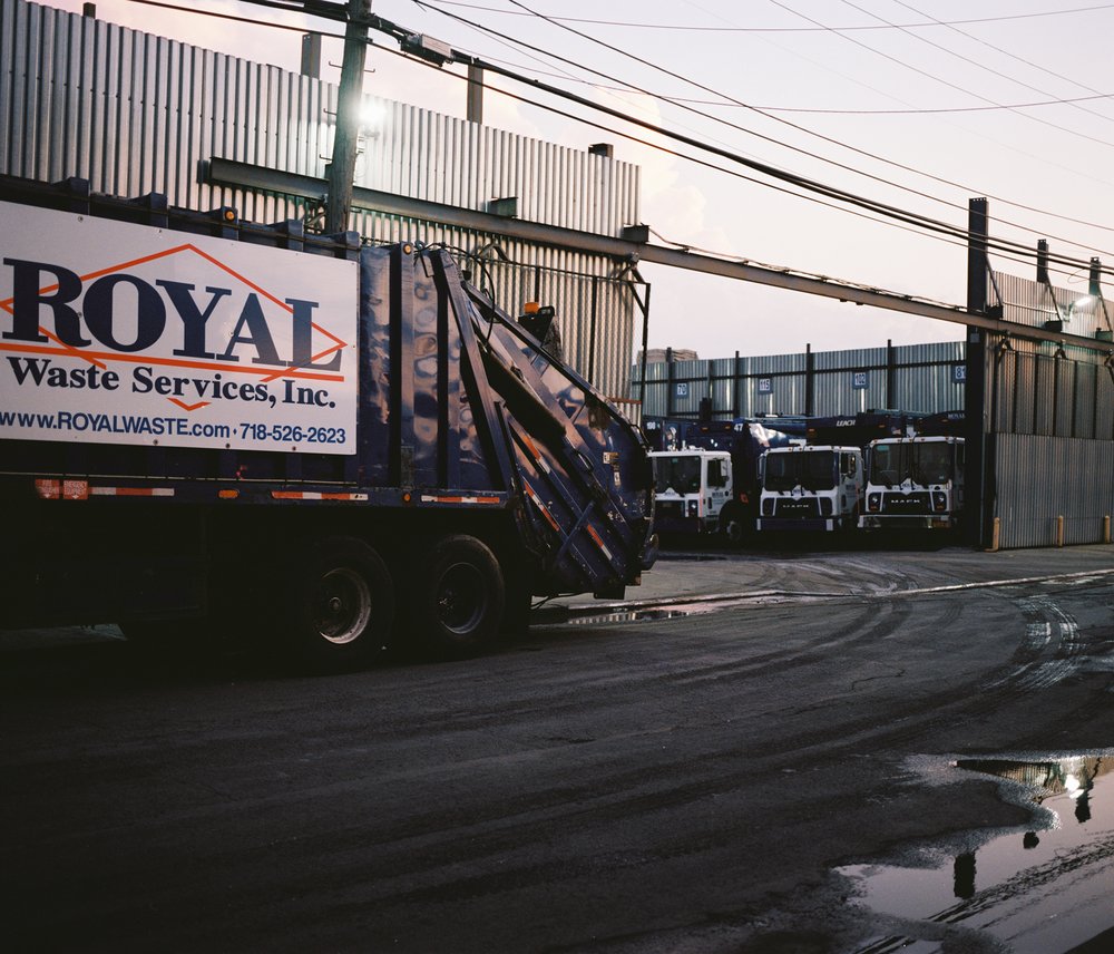 A garbage truck with a sign on its side that says "Royal Waste Services, Inc."