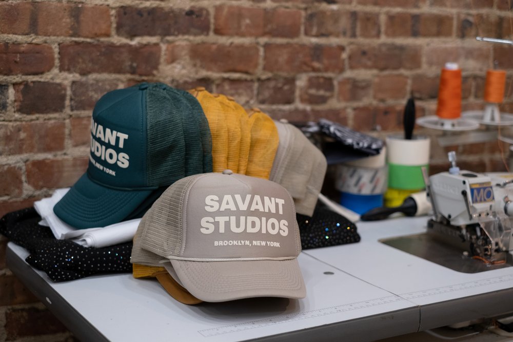 Trucker hats that say "SAVANT."