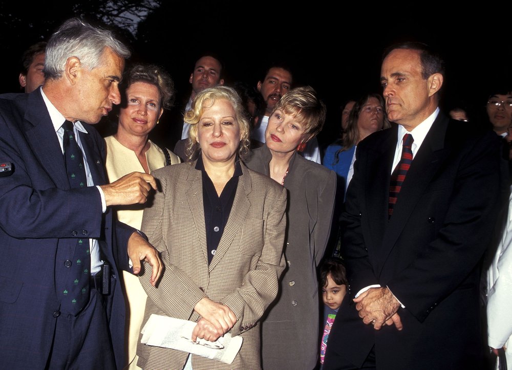 A photo of former Parks Commissioner Henry Stern holding forth with Bette Midler, Donna Hanover, Mayor Rudy Giuliani and others at the Little Red Lighthouse Cleanup on June 12, 1995 at Fort Washington Park in New York City.
