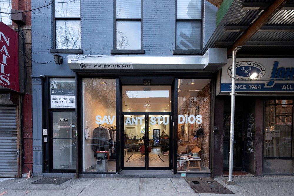 The exterior of a store that says "Savant Studios."