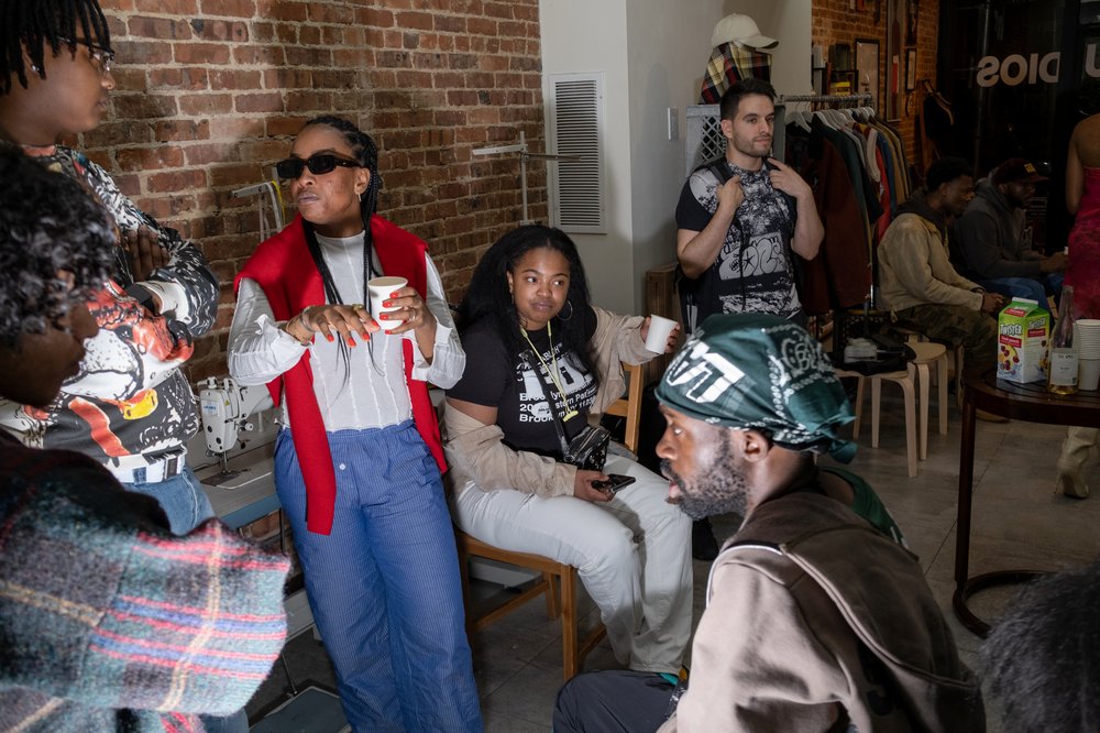 A group of people talk inside a retail store.