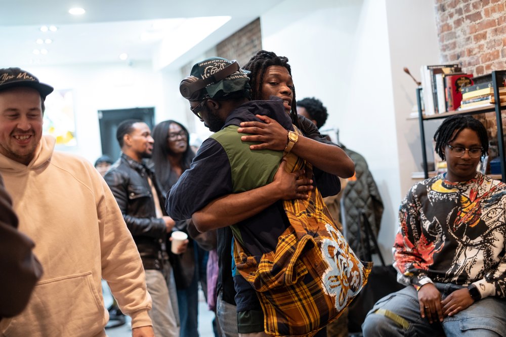 Two people hug inside a clothing store