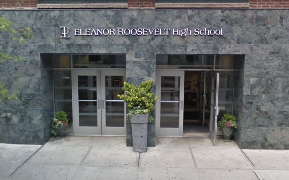 The front entrance to Eleanor Roosevelt High School with two big vases flanking the entrance.