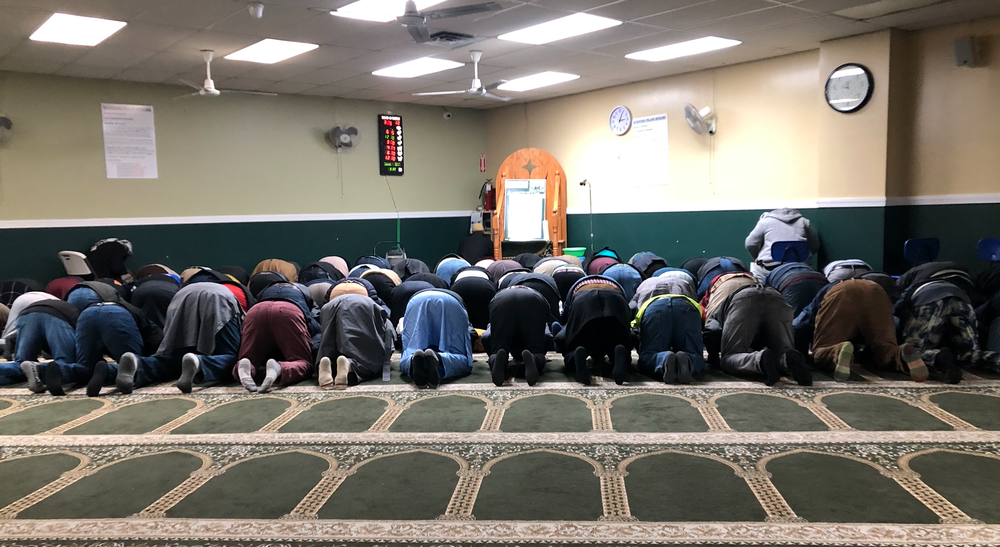 Men praying at Masjid-Ur-Rahmah on Monday