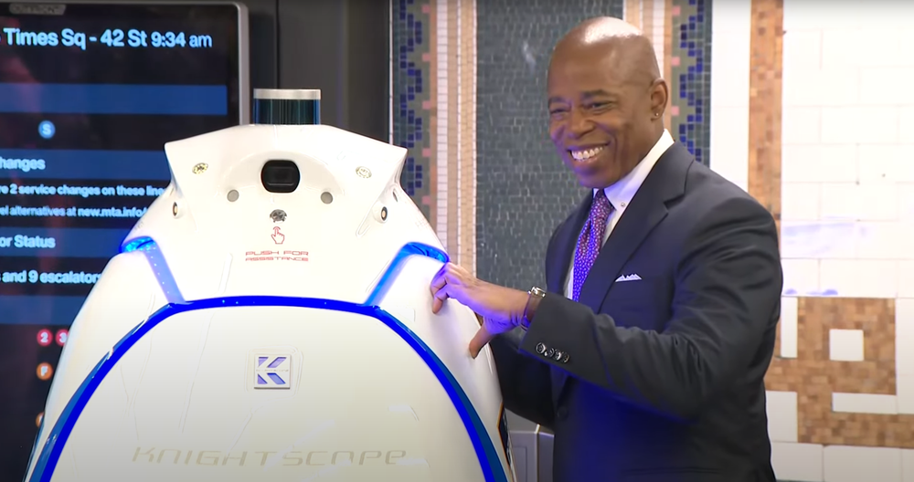 Mayor Eric Adams mayor makes a half-heart shape with his hand, pressing it to the K5’s waterproof exterior.