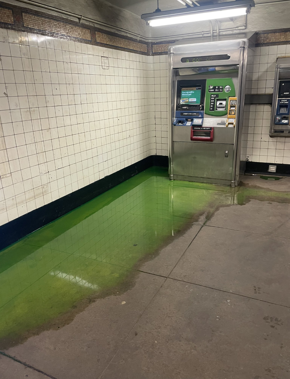 A photo of green ooze at a city subway stop