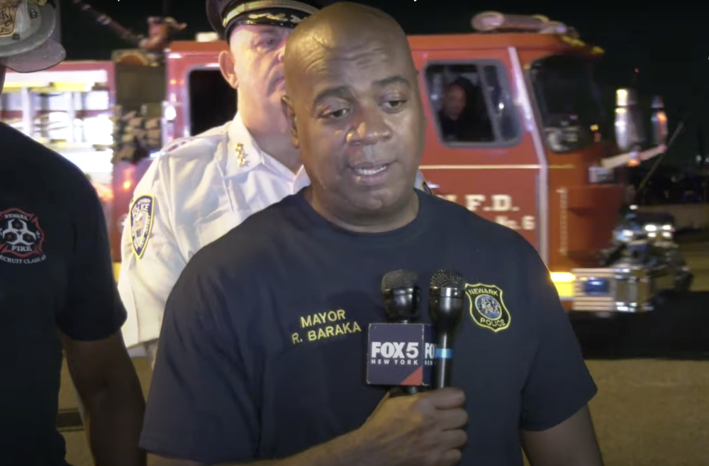 A photo of Newark Mayor Ras Baraka addressing reporters after two firefighters were killed aboard a cargo ship