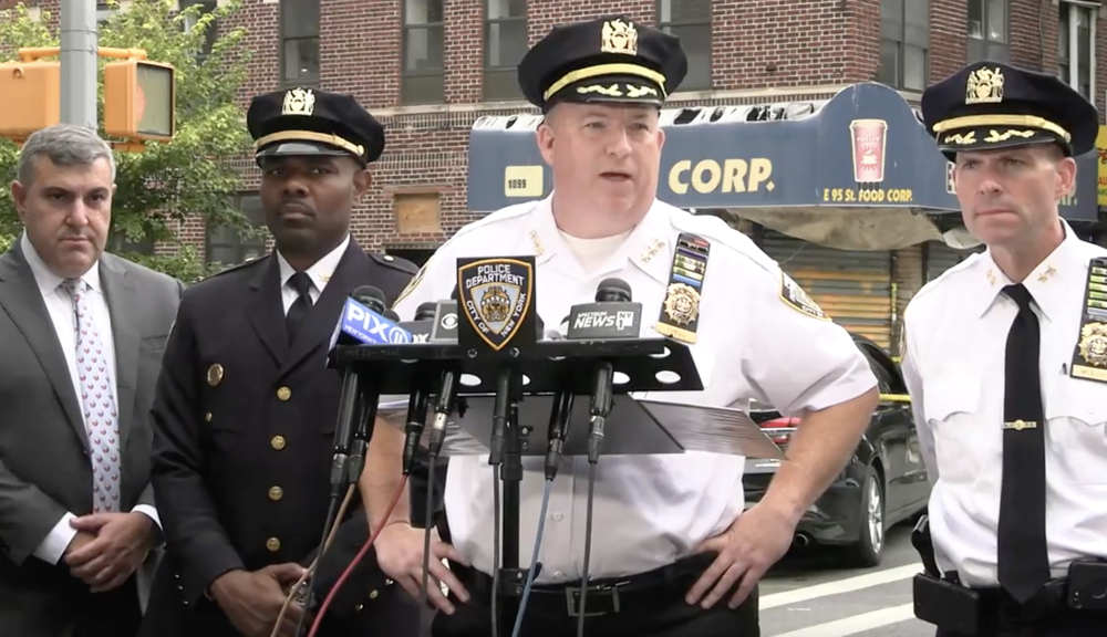 Police brief the media after a shooting in Brooklyn on Thursday.